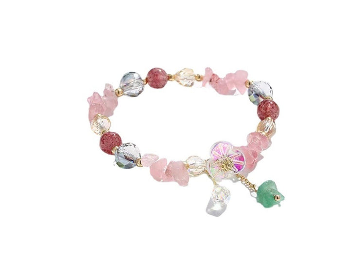 a bracelet with charms and beads on a white background