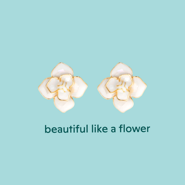 a pair of earrings with a flower on it